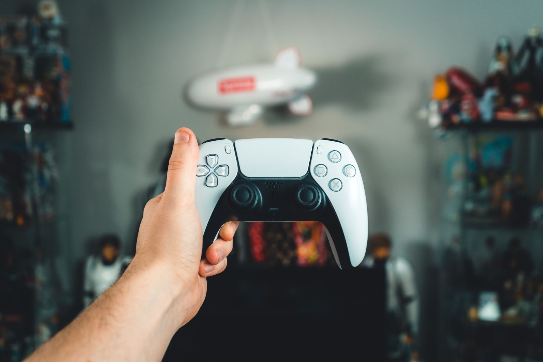 A close-up of a hand holding a sleek white gaming controller, showcasing modern design. — Elevate Your Gaming with Paradise W